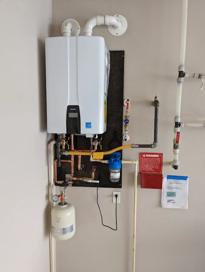 Professional plumber installing copper piping in a Dix home